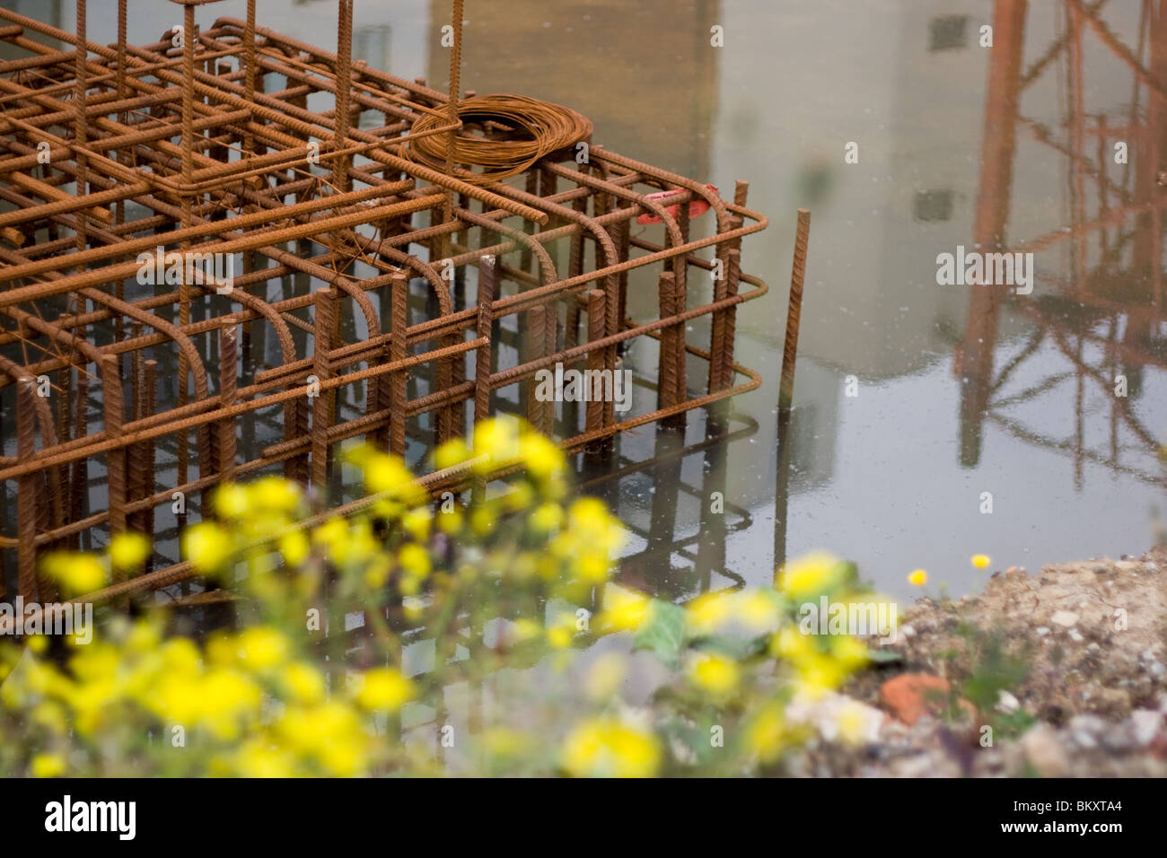 Rusty grate water abandoned building site in Manchester recession has caused the contractors to stop building due to money. Stock Photo