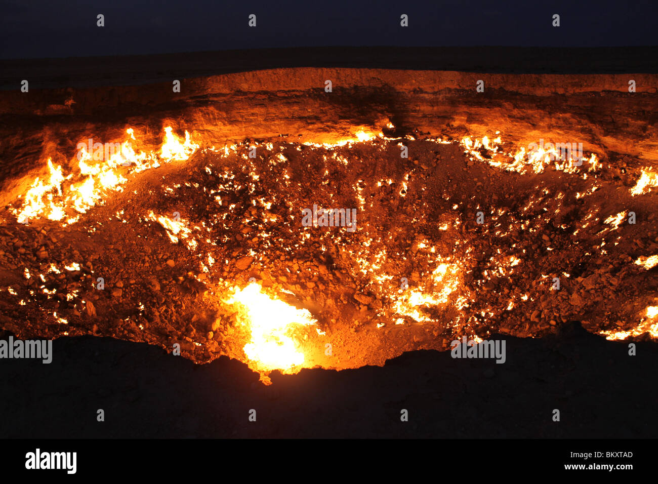 Derweze or Darvaza, aka the Door to Hell is a huge crater of burning natural gas in the Kara-kum desert in Turkmenistan. Stock Photo