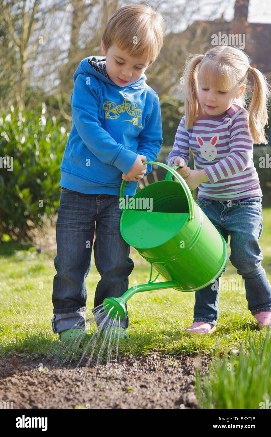 Girl And Boy Watering Plants High Resolution Stock Photography and ...