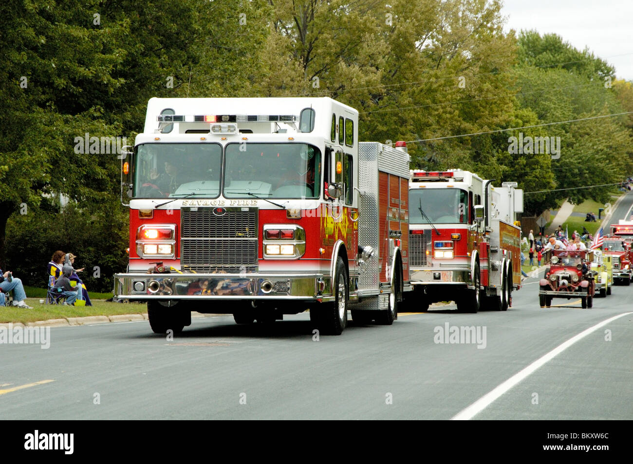 Fire and rescue vehicles being driven in a fire muster parade Stock