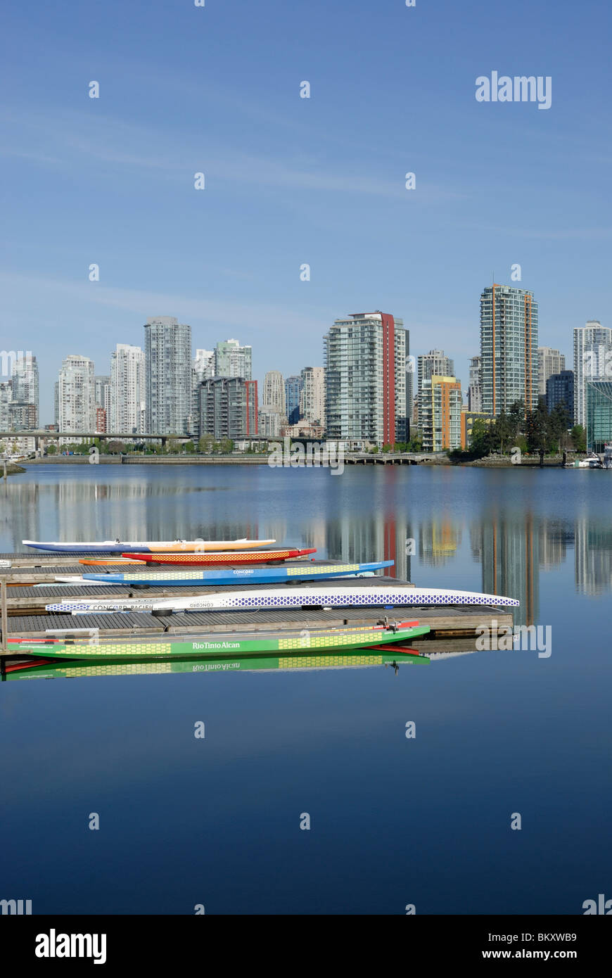 Skyline of False Creek, in Beautiful Vancouver City, with resting Dragon Boats in the foreground. Stock Photo