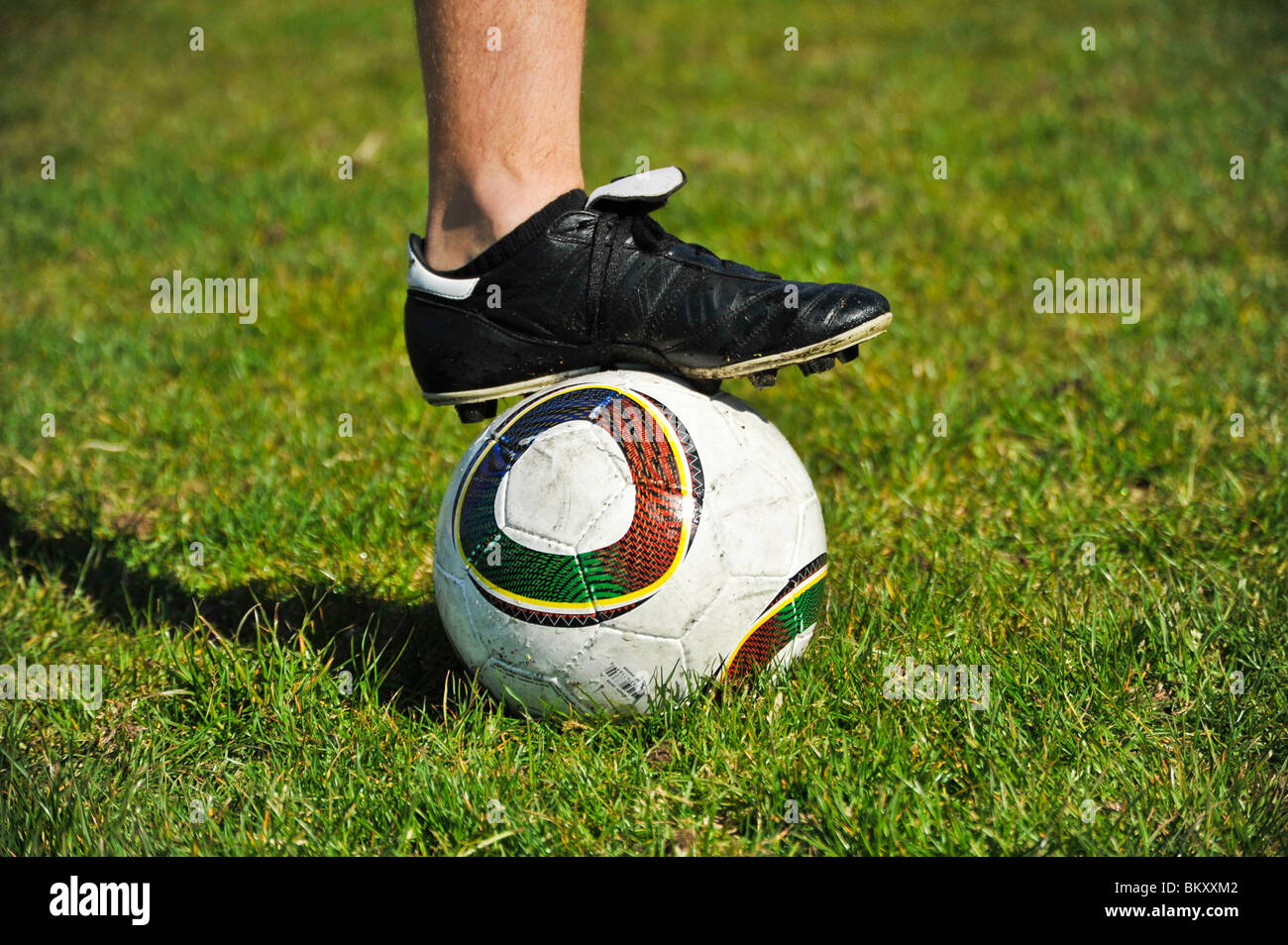A close up view of a male soccer player's foot on a soccer ball Stock Photo