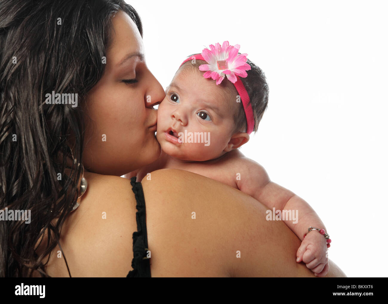 large Hispanic mother holding and kissing cute little newborn baby on the  cheek on white background Stock Photo - Alamy, image size:1300x1018