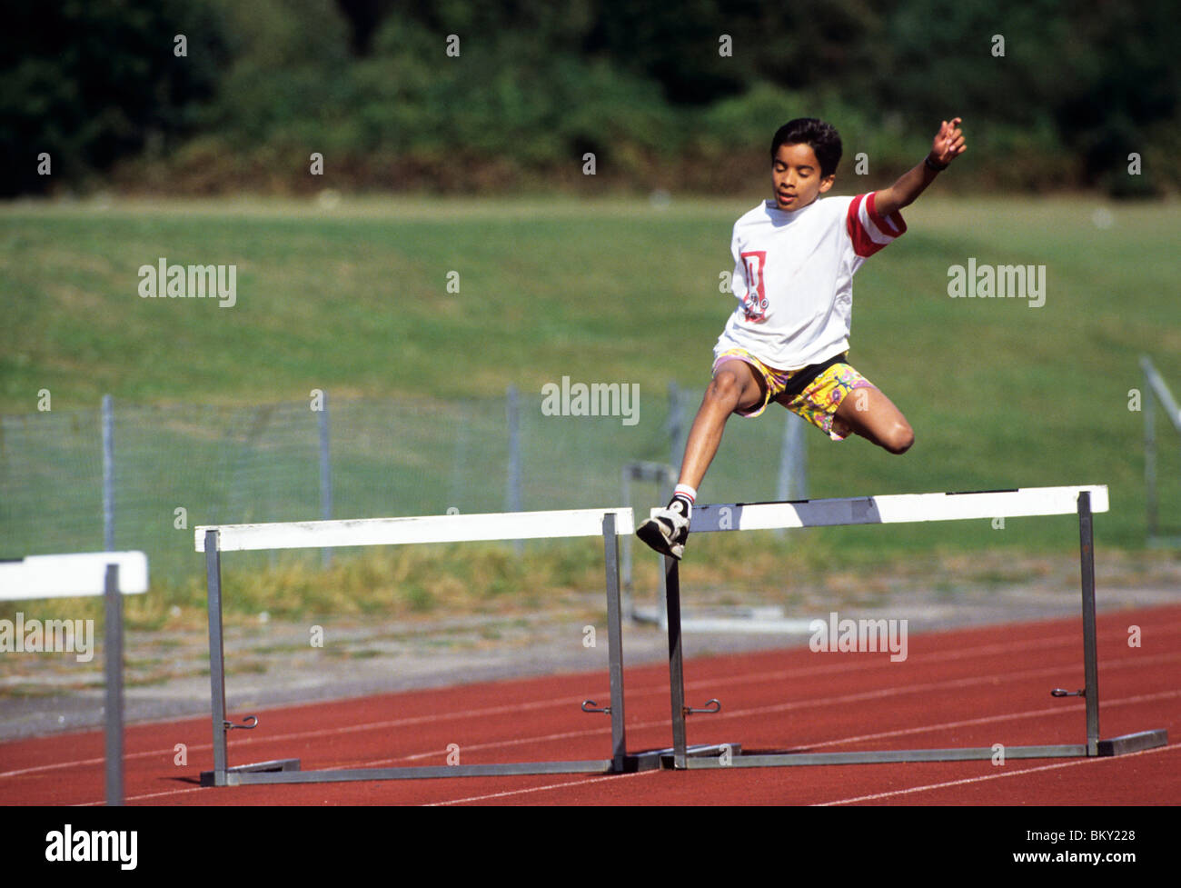 Boy running hurdles hires stock photography and images Alamy