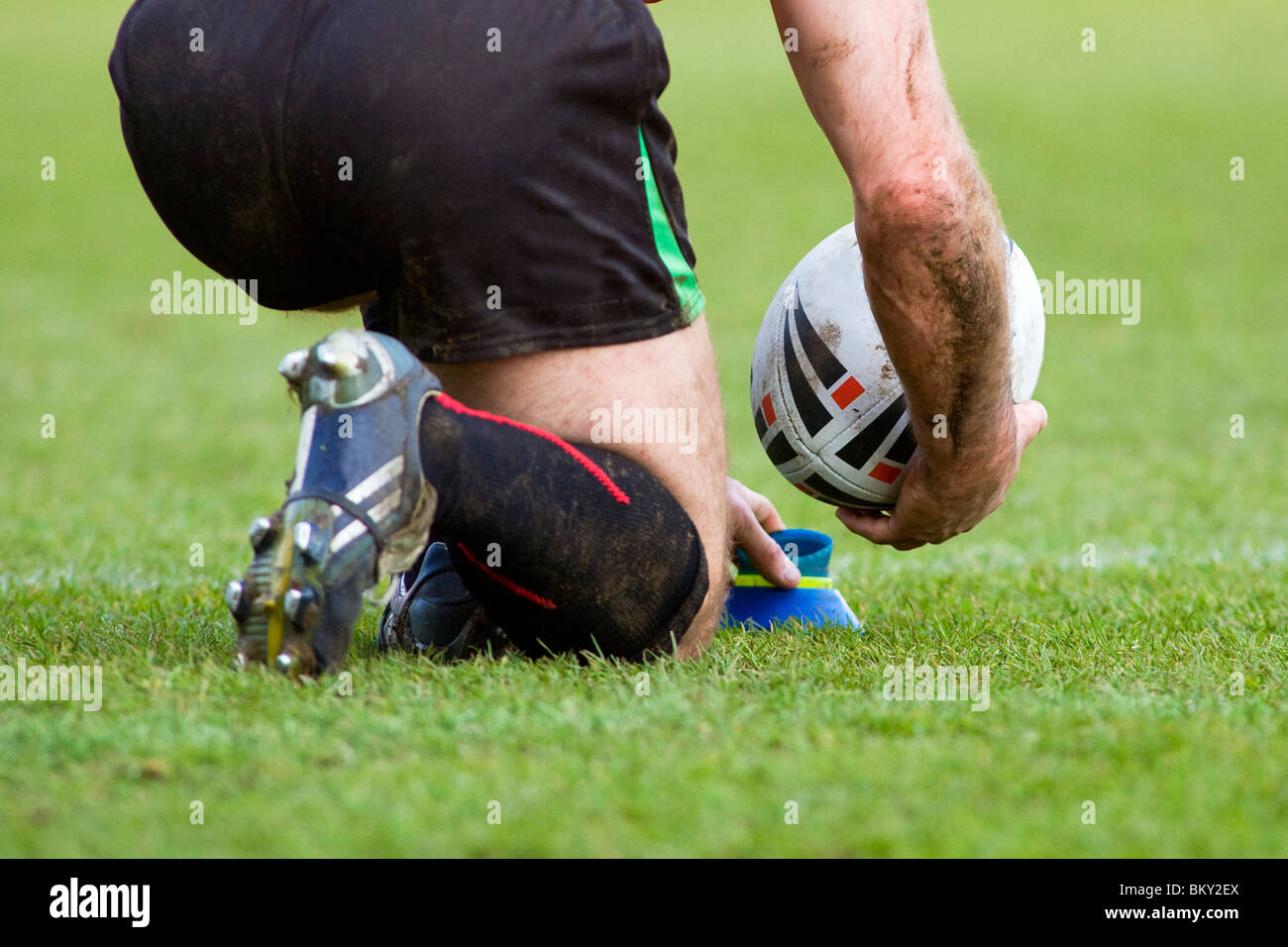 Rugby player lines up a penalty kick on kicking stand Stock Photo Alamy