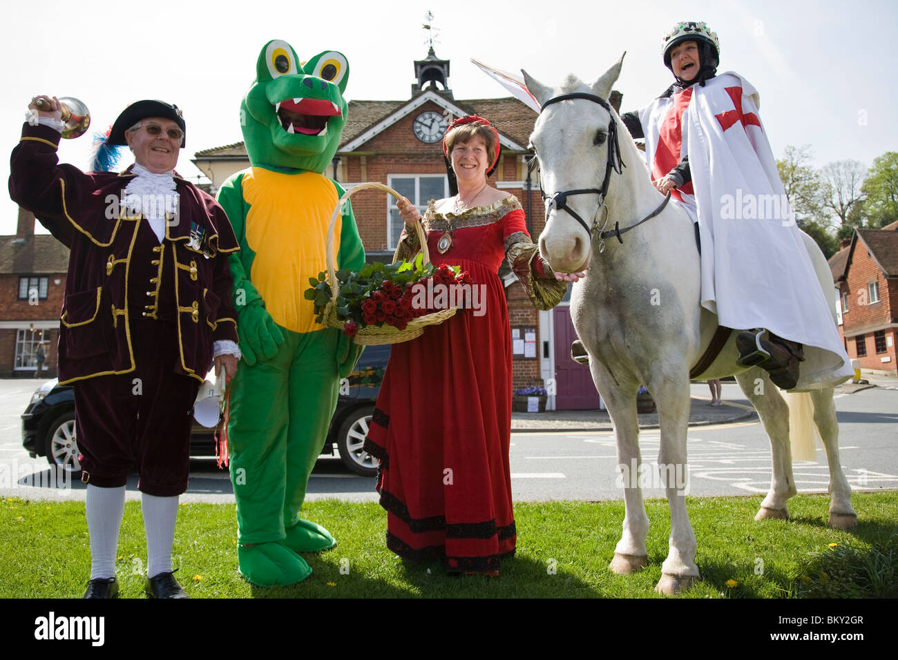 A group of characters assemble outside the Town Hall in the High Street on St George's day, Haslemere, Surrey, England. Stock Photo
