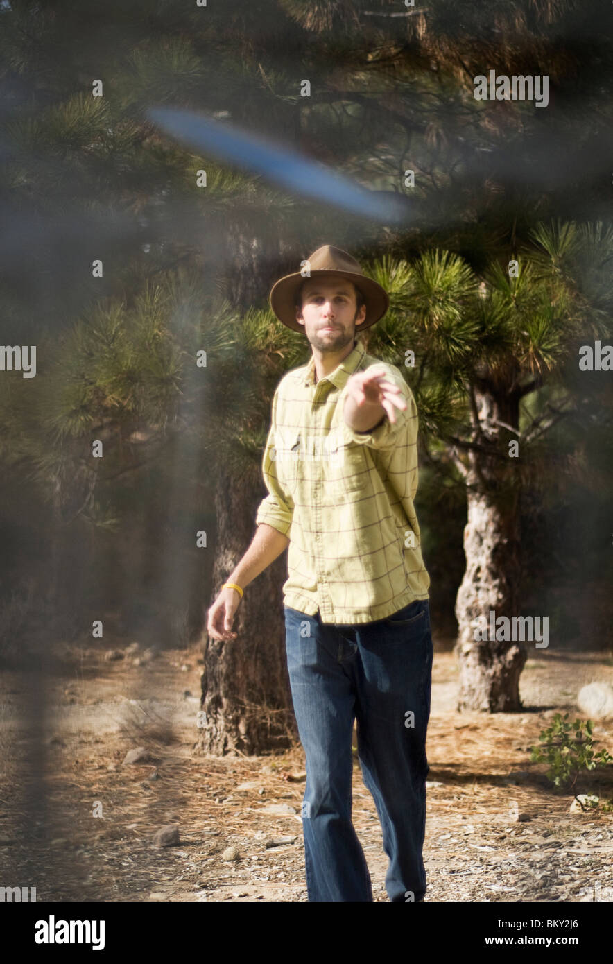 A young man shoots for par during a game of disc golf in Lake Tahoe, California. Stock Photo