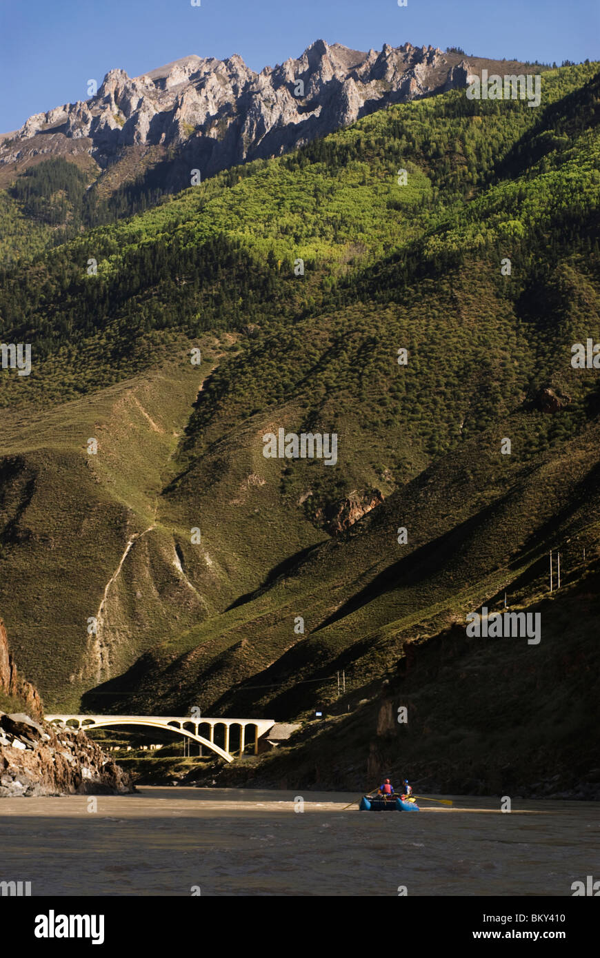 A rubber raft rows downstream during a whitewater rafting trip to ...