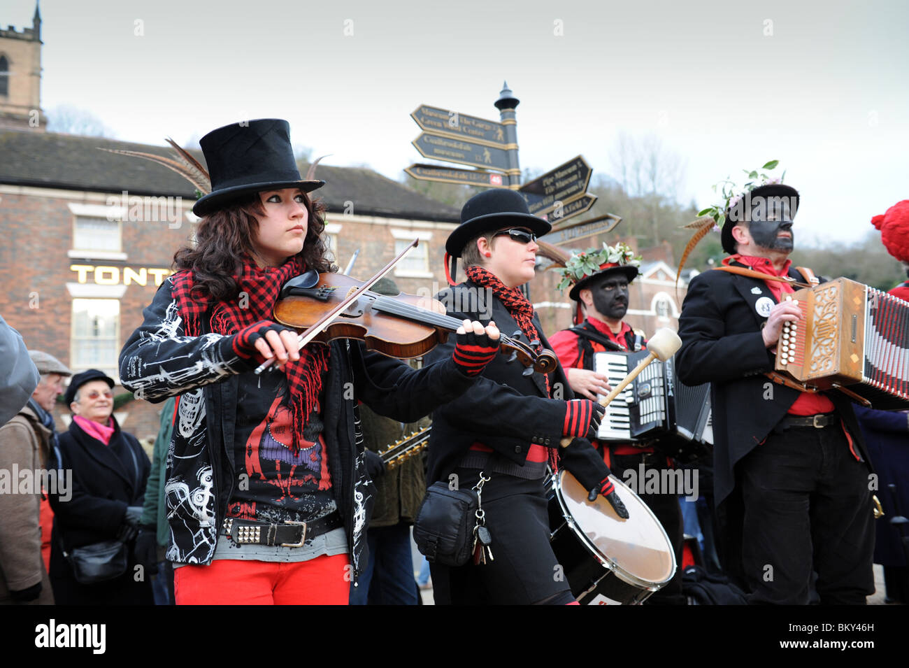 Female violinist and drummer with The Ironmen and Severn Gilders morris dancers performing on the Ironbridge on New Years Day Stock Photo