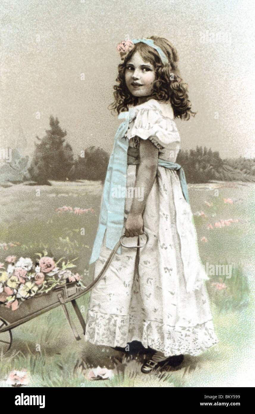 Young Girl pushing a Wheelbarrow full of flowers Stock Photo - Alamy