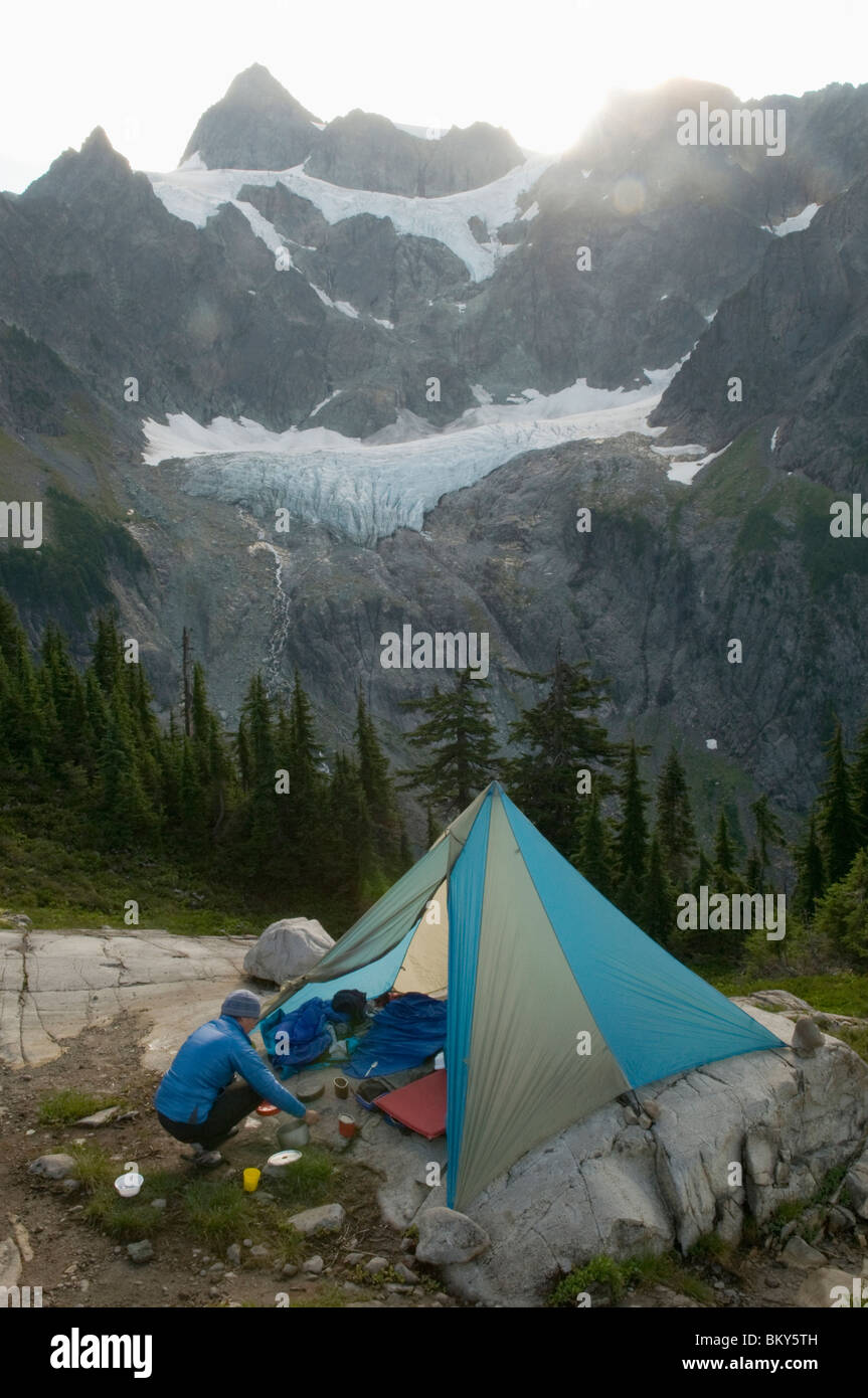 A woman camping at Lake Ann, Mount Baker Wilderness, Bellingham, Washington. Stock Photo