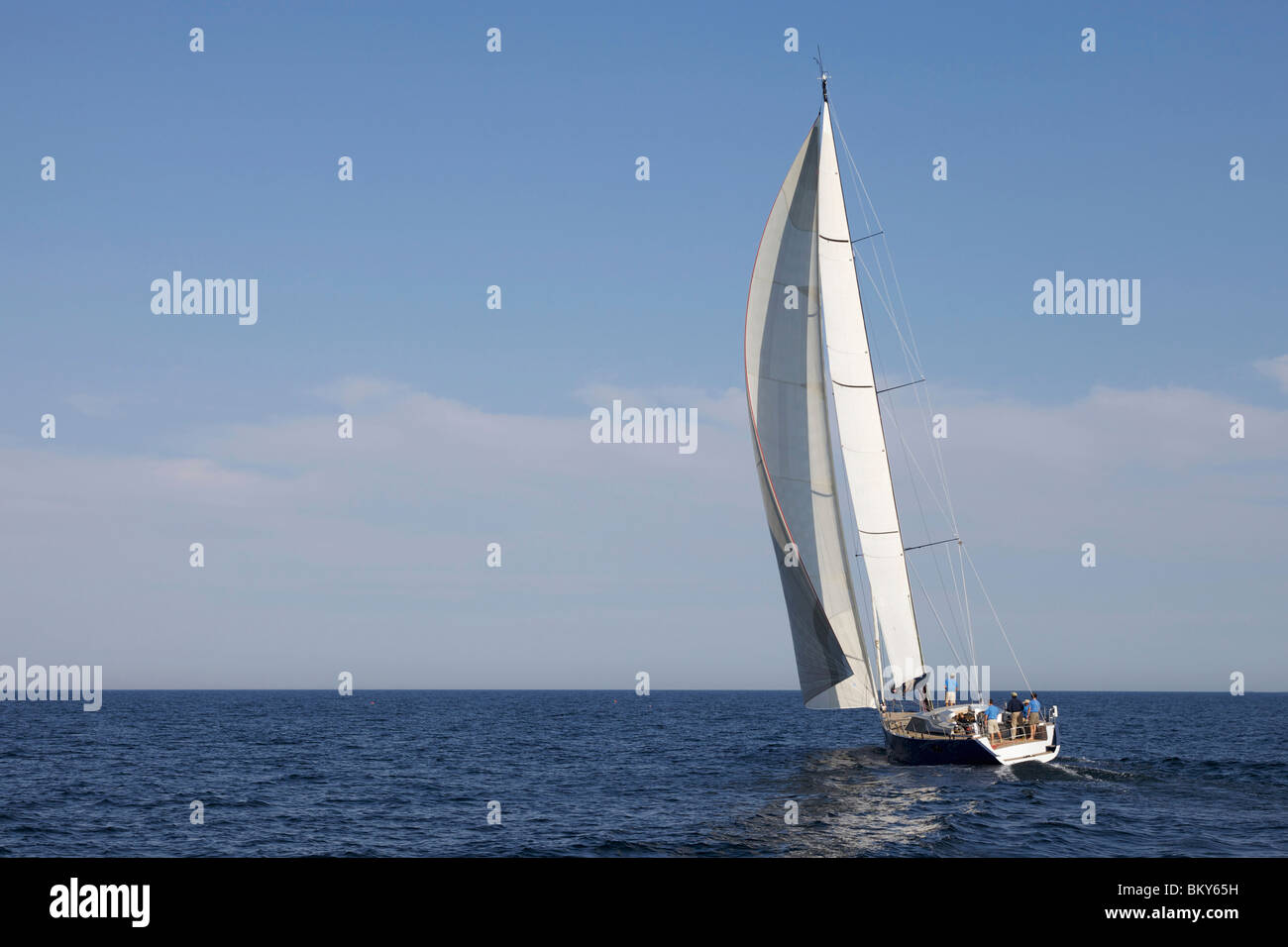 A crew races a modern ocean-going sailing yacht. Stock Photo