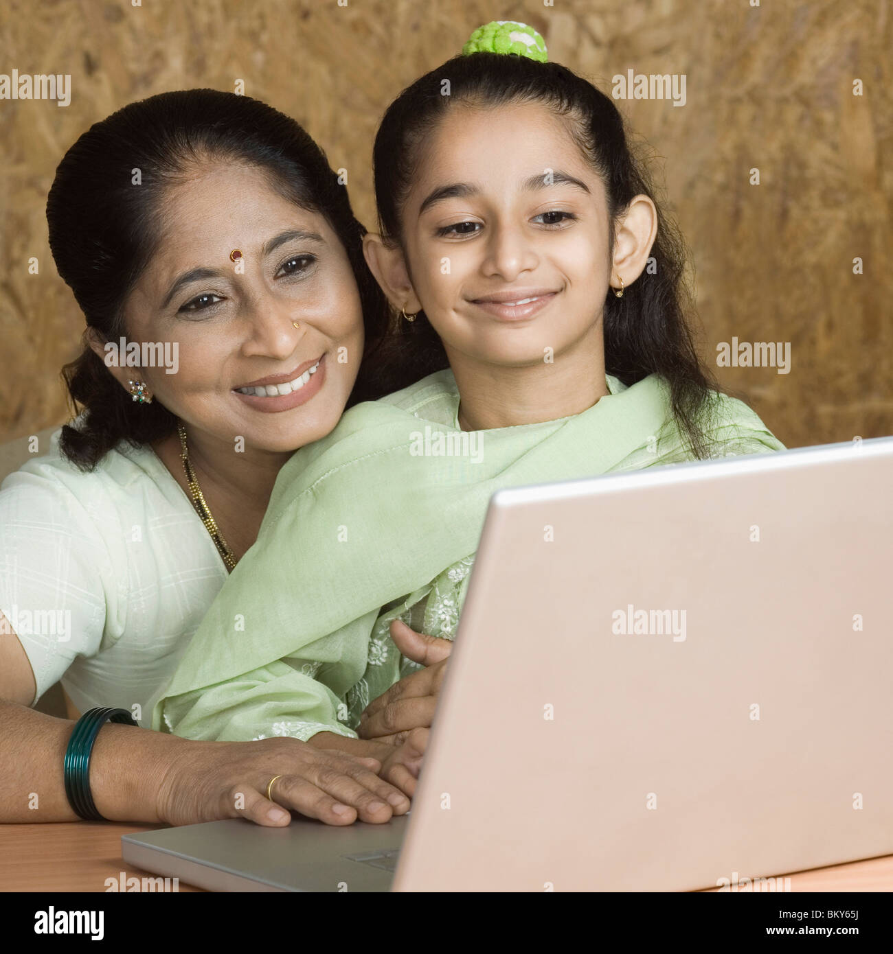 Girl using a laptop with her grandmother Stock Photo - Alamy