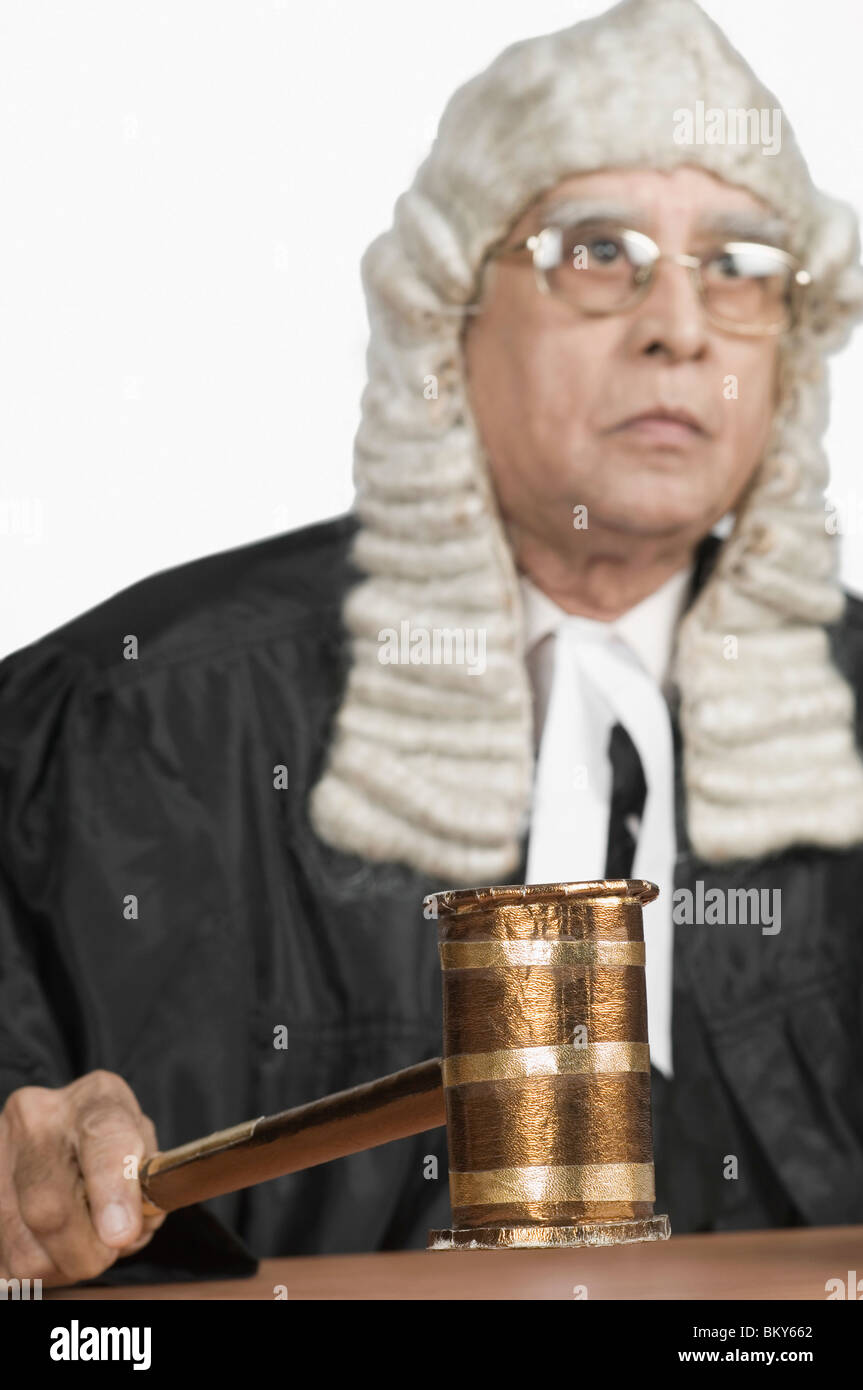 Closeup of judge hitting the gavel on desk Stock Photo Alamy