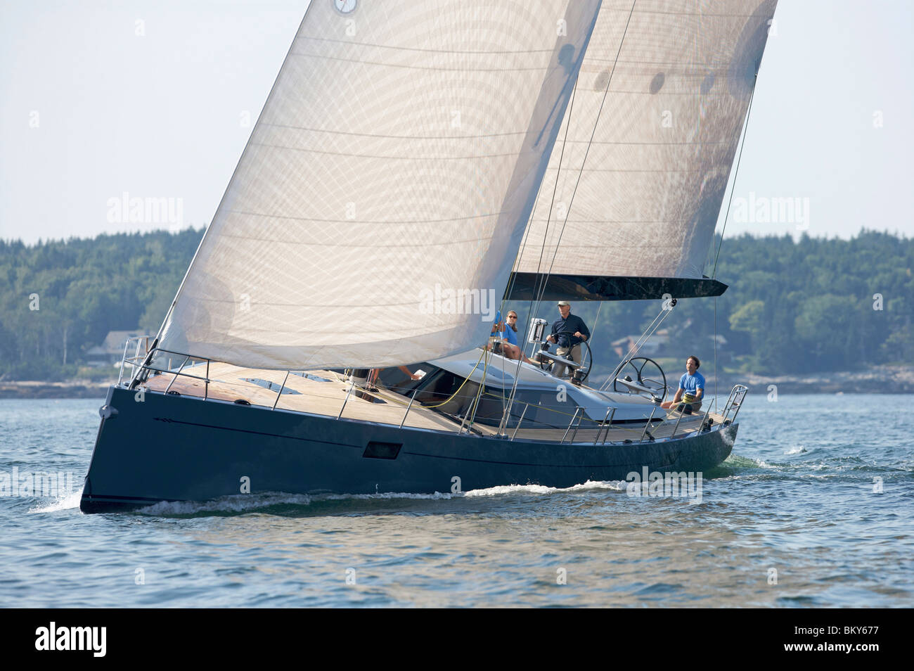 A crew races a modern ocean-going sailing yacht. Stock Photo