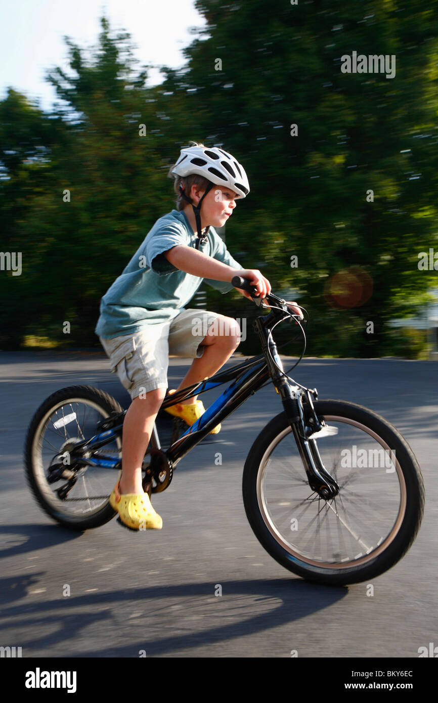 Boy rides his bike on a driveway Stock Photo Alamy