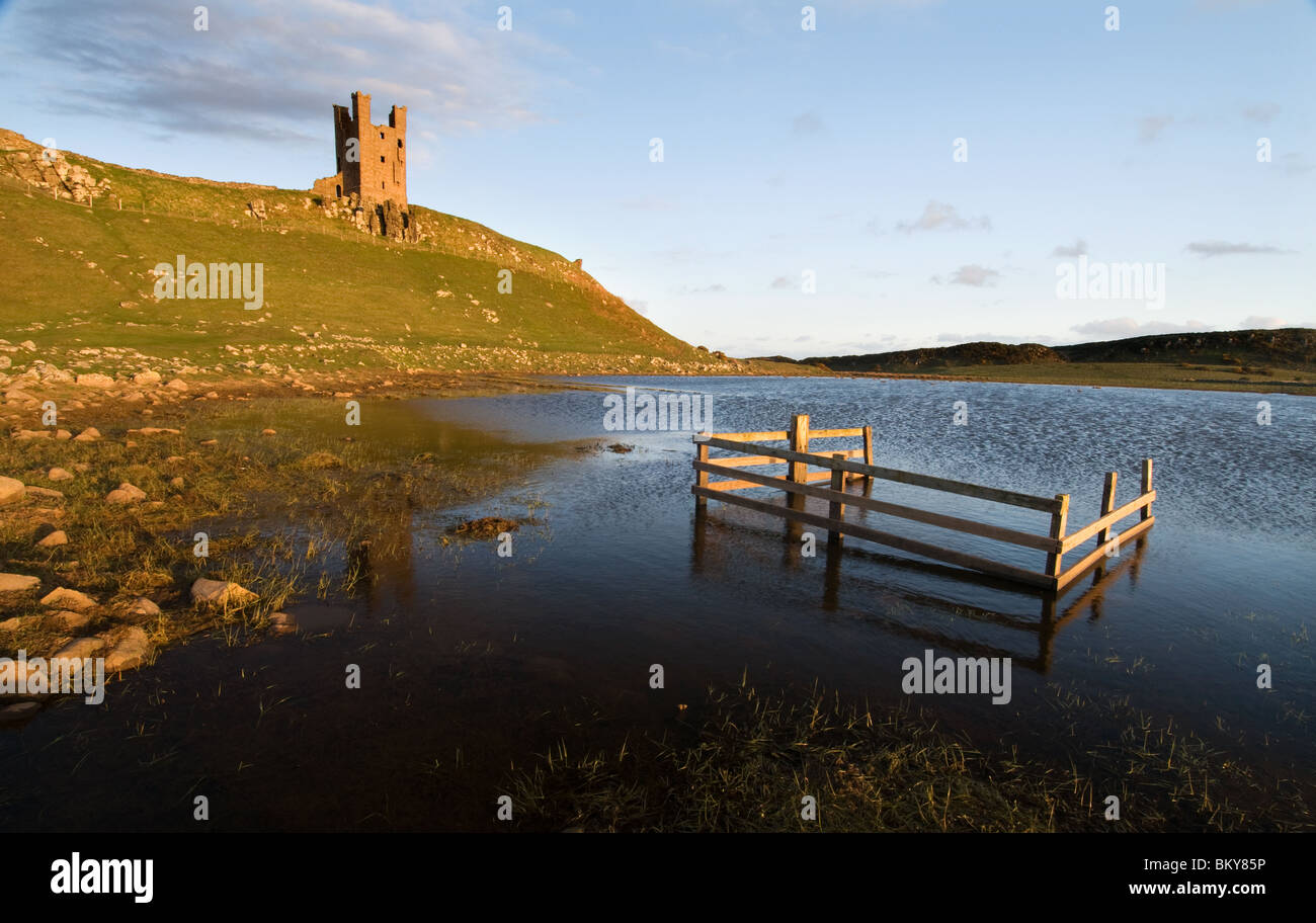 Dunstanburgh Castle in early evening sunlight Stock Photo