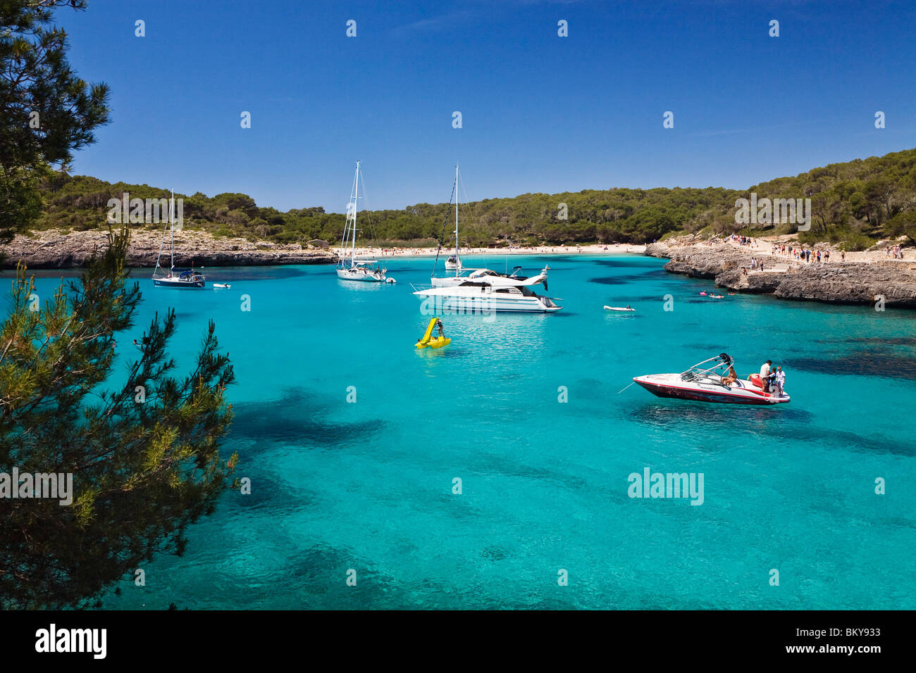 Sailing yachts anchoring in the bay of s'Amarador under blue sky, Cala Mondragó, Mallorca, Balearic Islands, Mediterranean Sea, Stock Photo