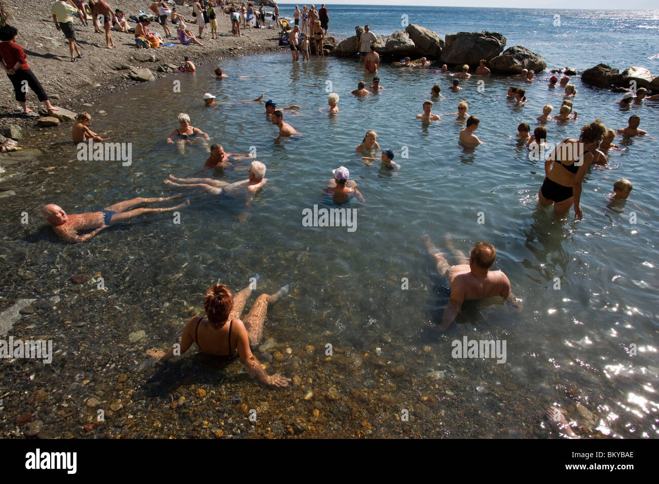 People bathing in the Embros Therme, a naturally 40 degree hot spring added with sulfit, knowing as health care, near Kos-Town, Stock Photo