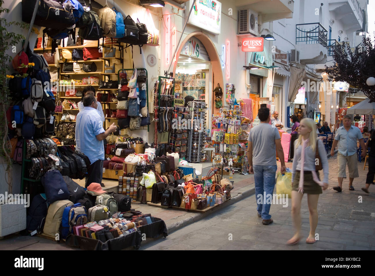 People passing a bag shop at shopping street Odos Ifestou in the evening,  old town, Kos-Town, Kos, Greece Stock Photo - Alamy
