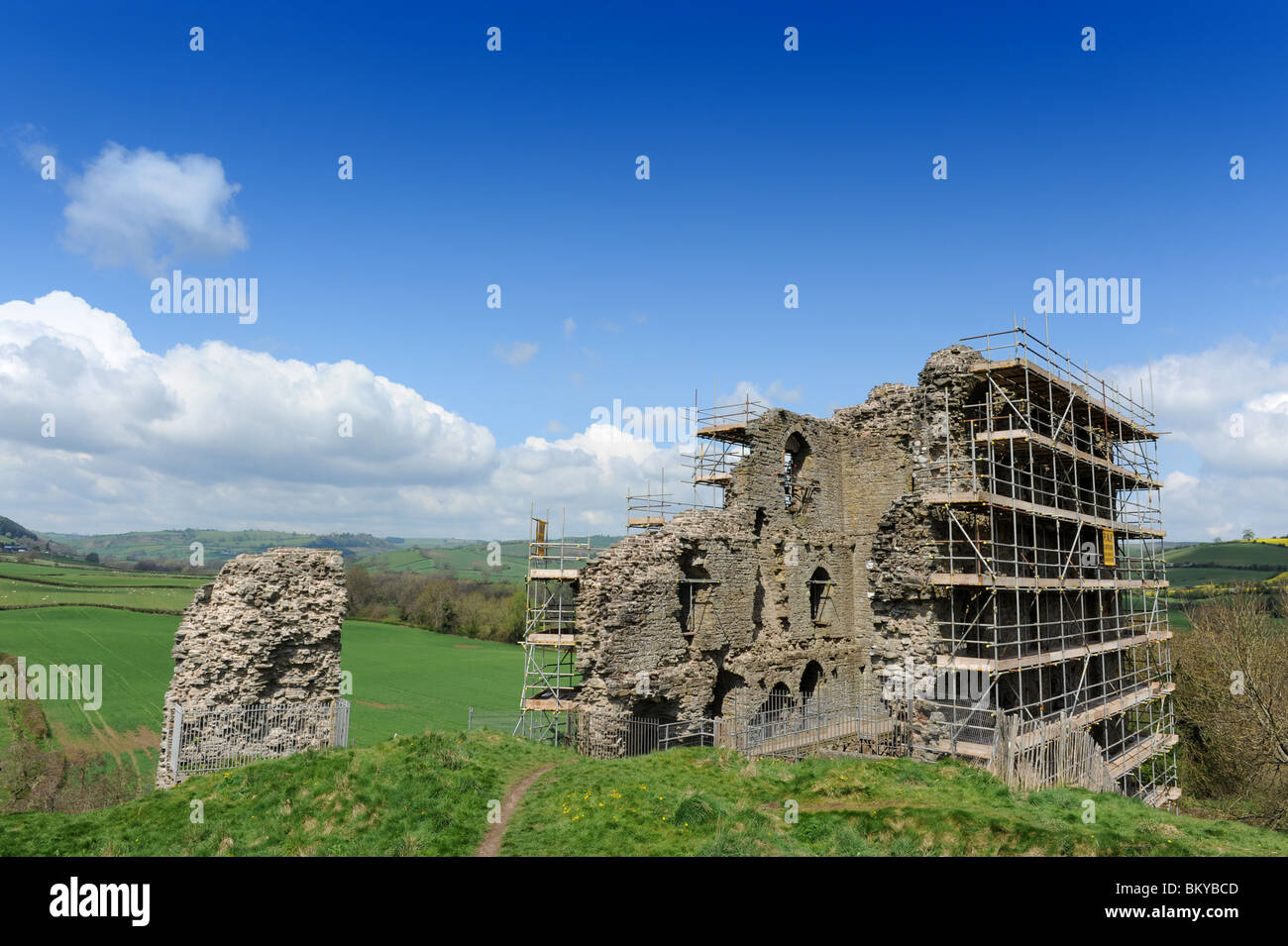 Remains of Clun Castle draped in scaffolding in Shropshire England Uk Stock Photo