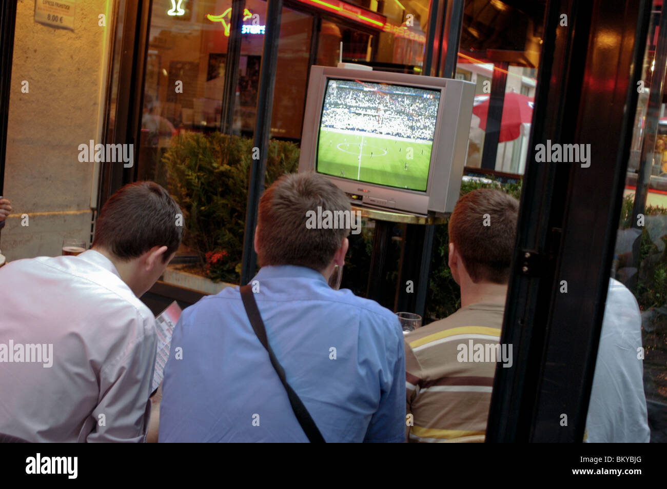group of friends on holiday city , Young Adults inside Bar, Paris, France, Looking at  Soccer Match on T.V. Screen, busy pub local neighborhood bar interior Stock Photo