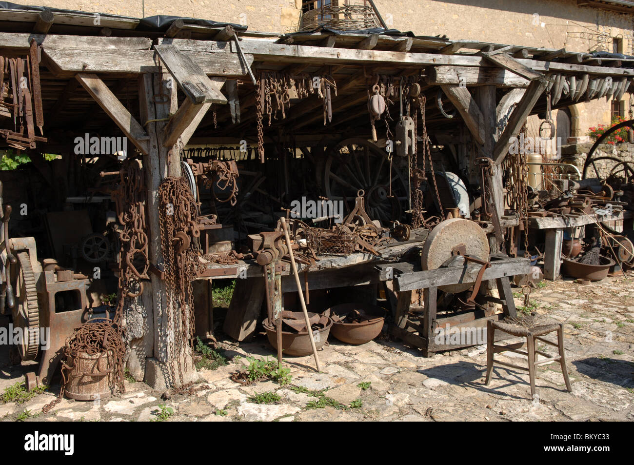 Old implements and machinery in rural France Old dusty tools in rural France at The Château de Sarzay a 14th-century castle in 2005 Stock Photo