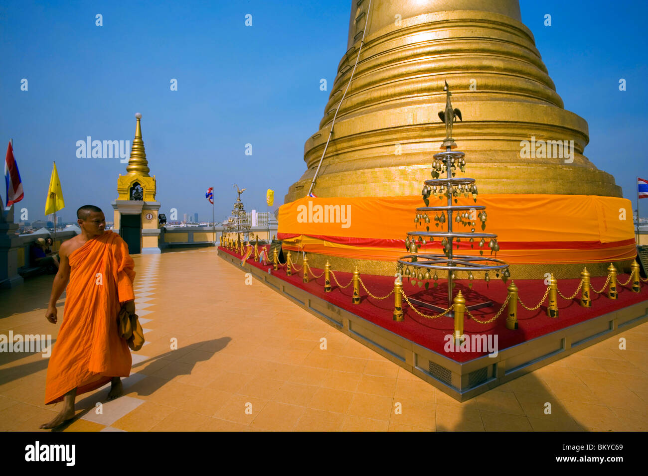 Monk visiting gilded Chedi, housed a Buddha relic of the Wat Saket on the Golden Mount, Bangkok, Thailand Stock Photo