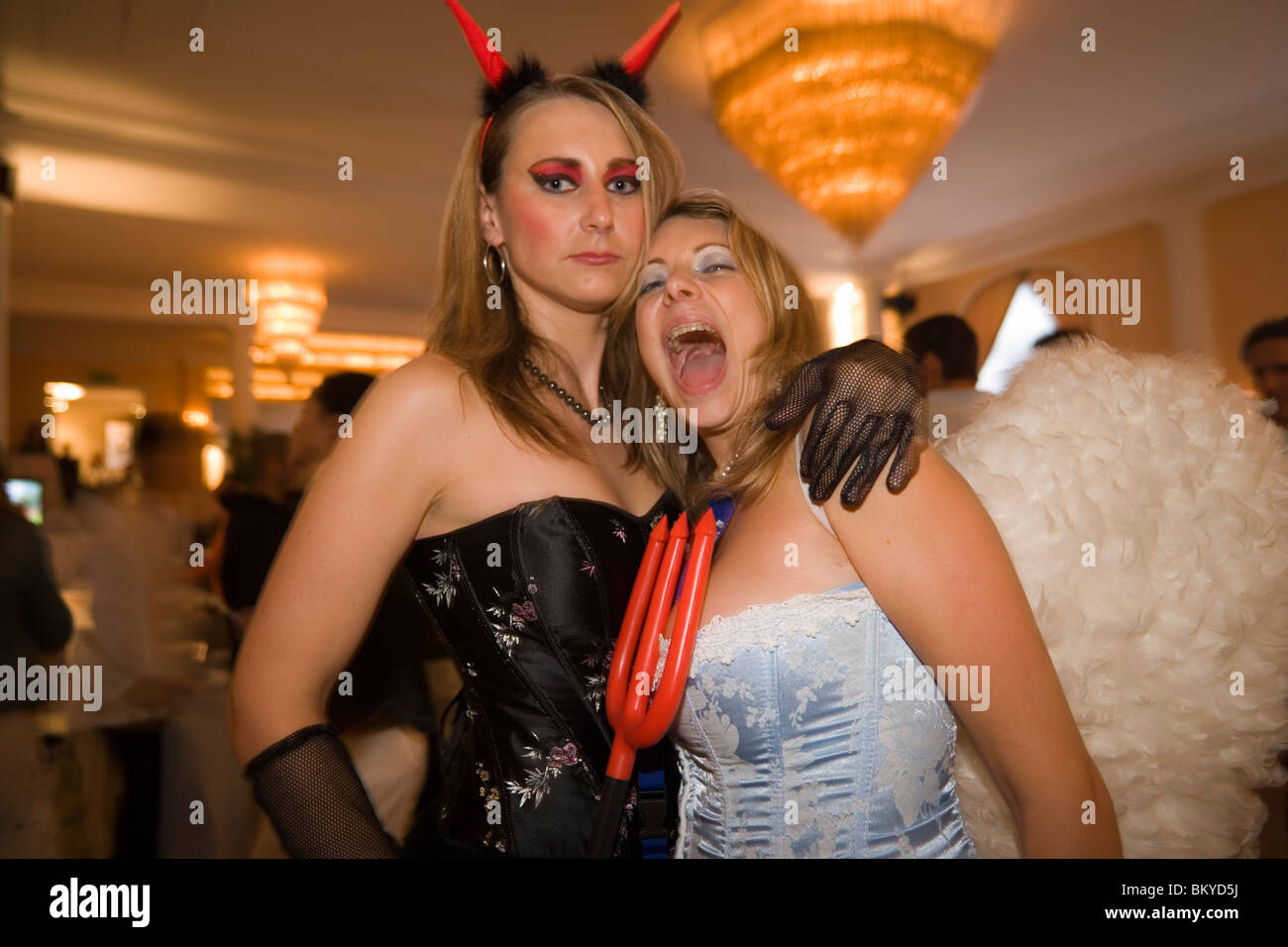 Portrait of two girls dressed up as angel and devil in the louge of the Baur au Lac Hotel, After Party of the Street Parade (the Stock Photo