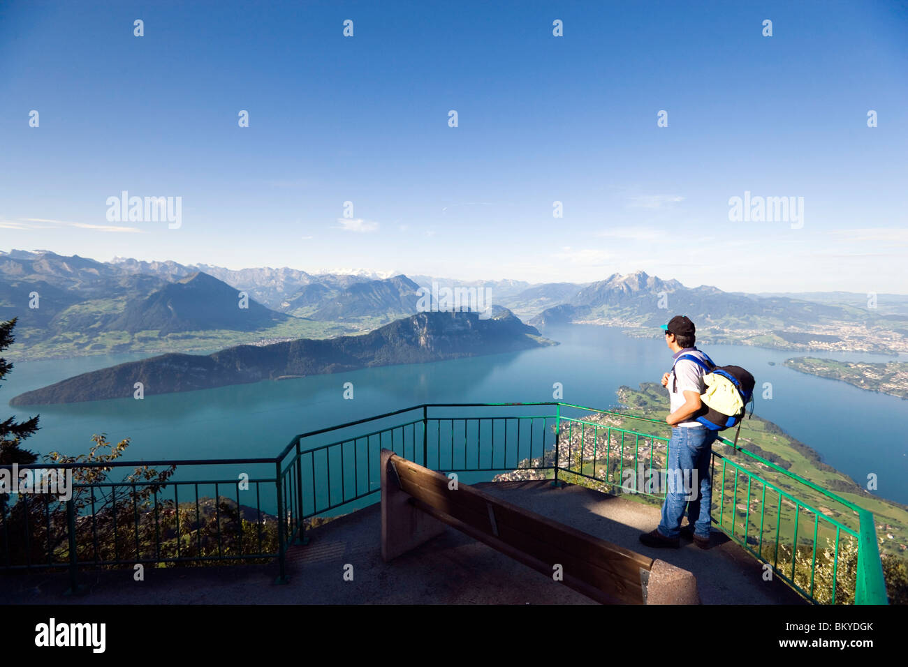 Man standing on vantage point Kaenzli, mount Rigi (1797 m, Queen of the Mountains) and looking over Lake Lucerne with Weggis, mo Stock Photo
