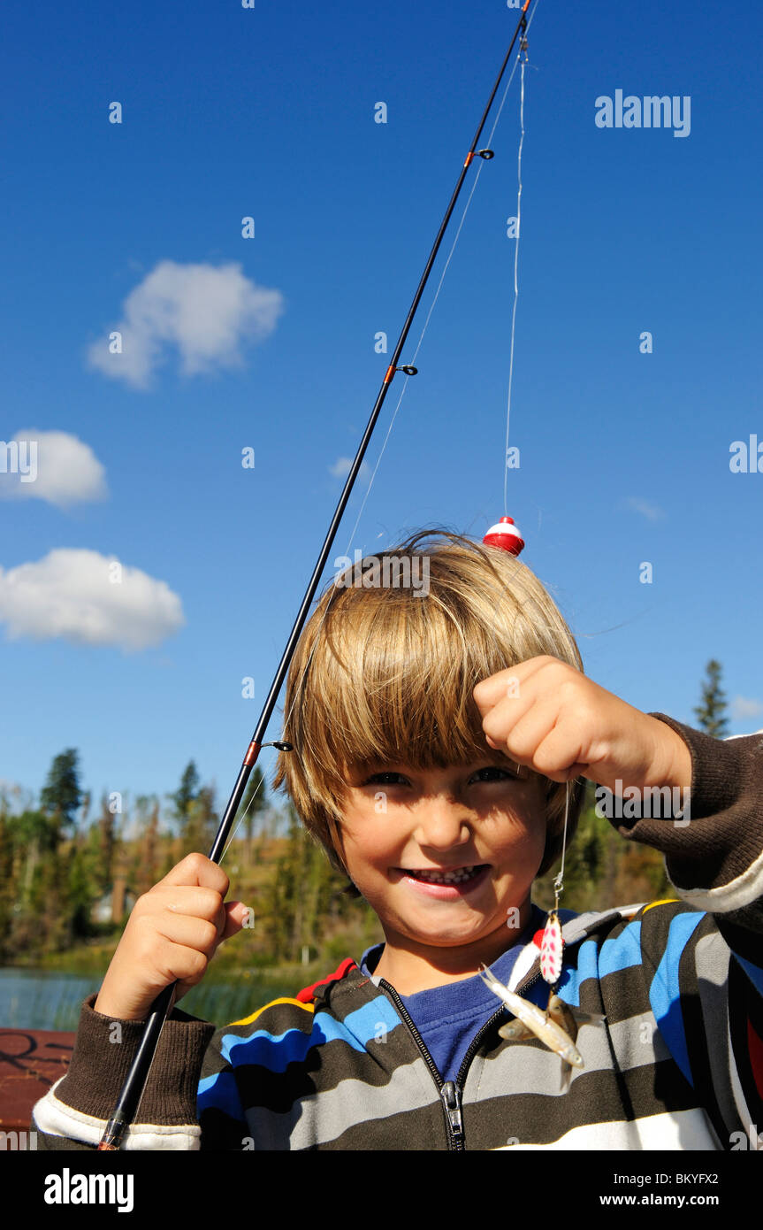blond teenage boy with fishing pole Fishing blond boy hi-res stock photography and images