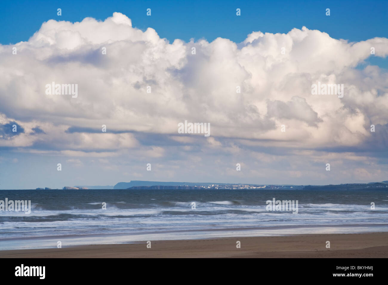 Cumulus clouds gathering over Benone Strand, and on the far horizon, Portstewart, County Down, Northern Ireland Stock Photo