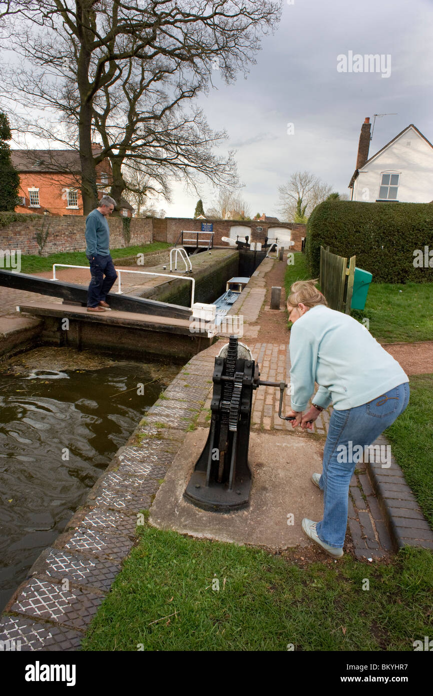 women opening lock on trent and mersey canal england Stock Photo