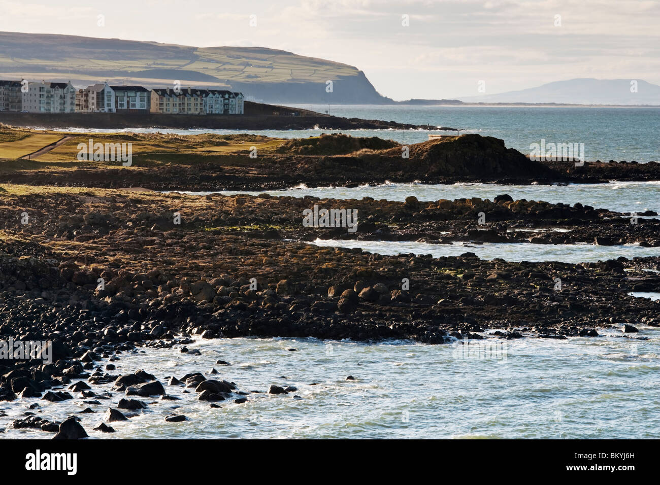 Looking west along the Northern Irish coast toward County Derry from the harbour at Portrush, County Antrim Stock Photo