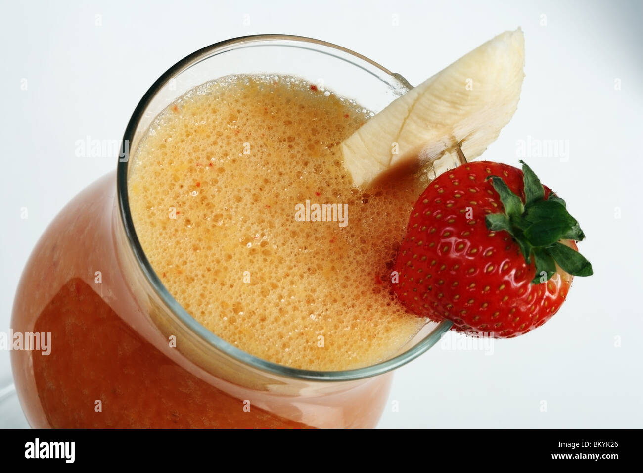Banana and strawberry smoothies. Close-up on a grey background. Stock Photo