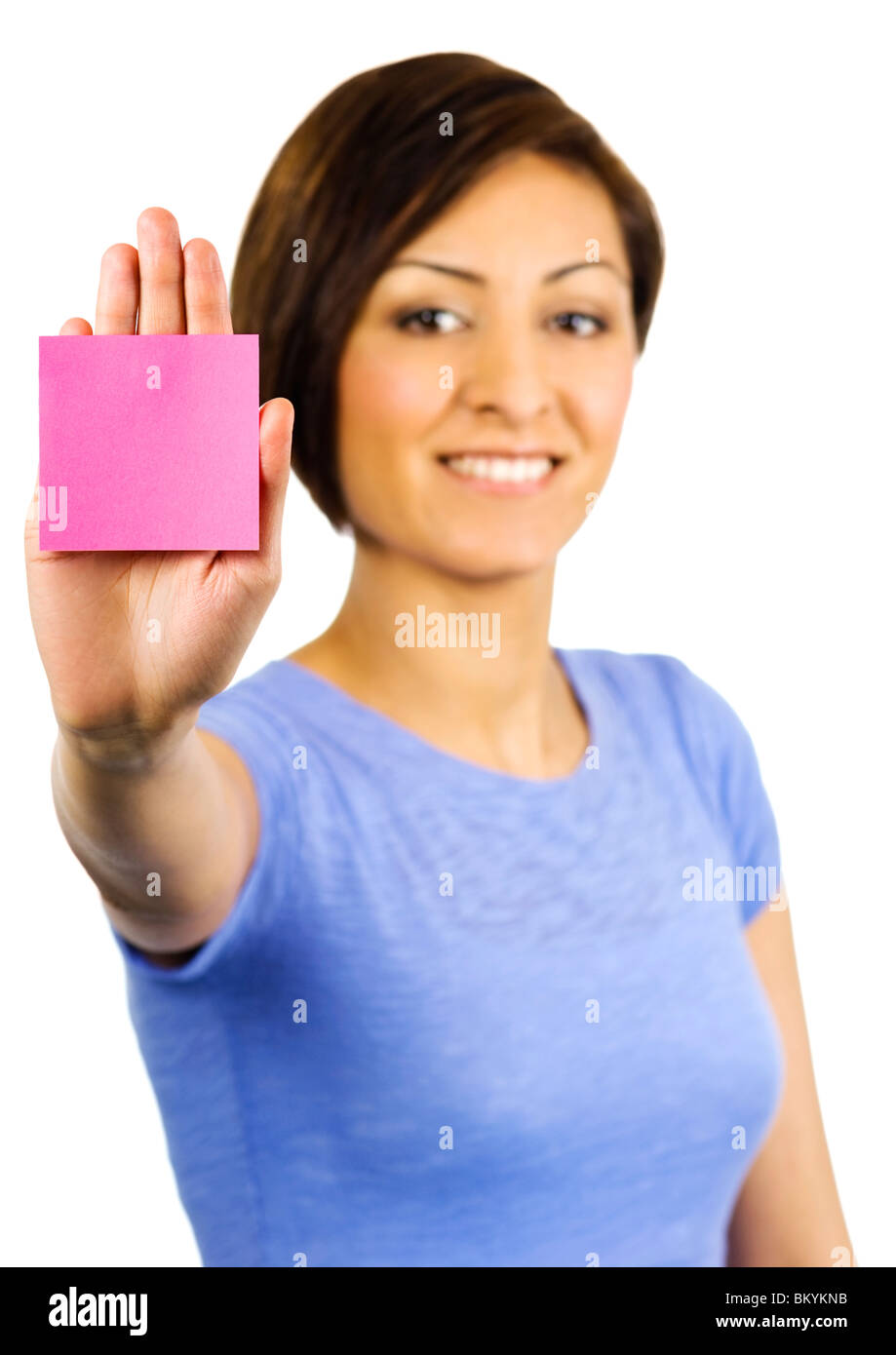 Young woman has a pink sticky note on the palm of her outstretched hand Stock Photo