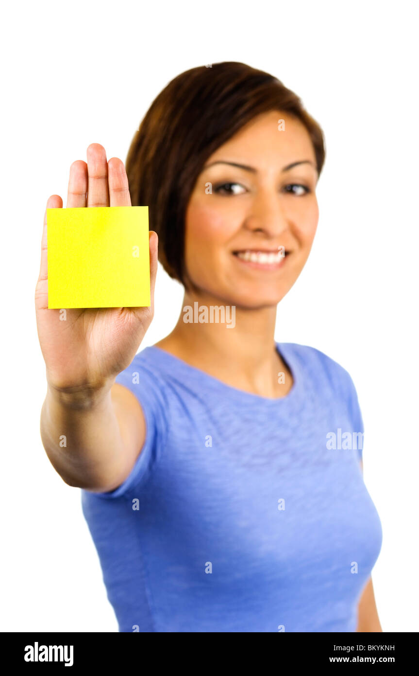Young woman has a yellow sticky note on the palm of her outstretched hand Stock Photo
