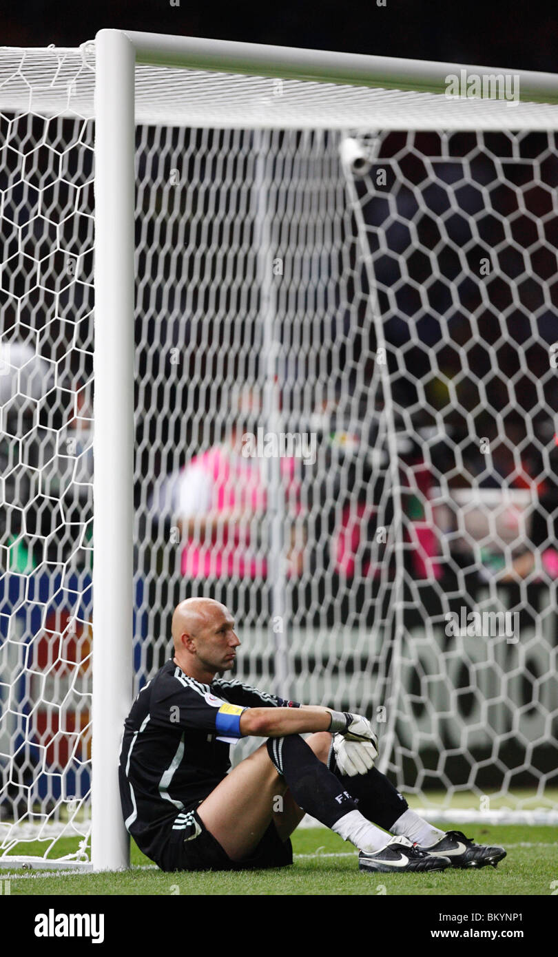Dejected Goalkeeper Fabien Barthez Of France Sits Against The Goal Post After Italy Defeated France To Win The 06 World Cup Stock Photo Alamy