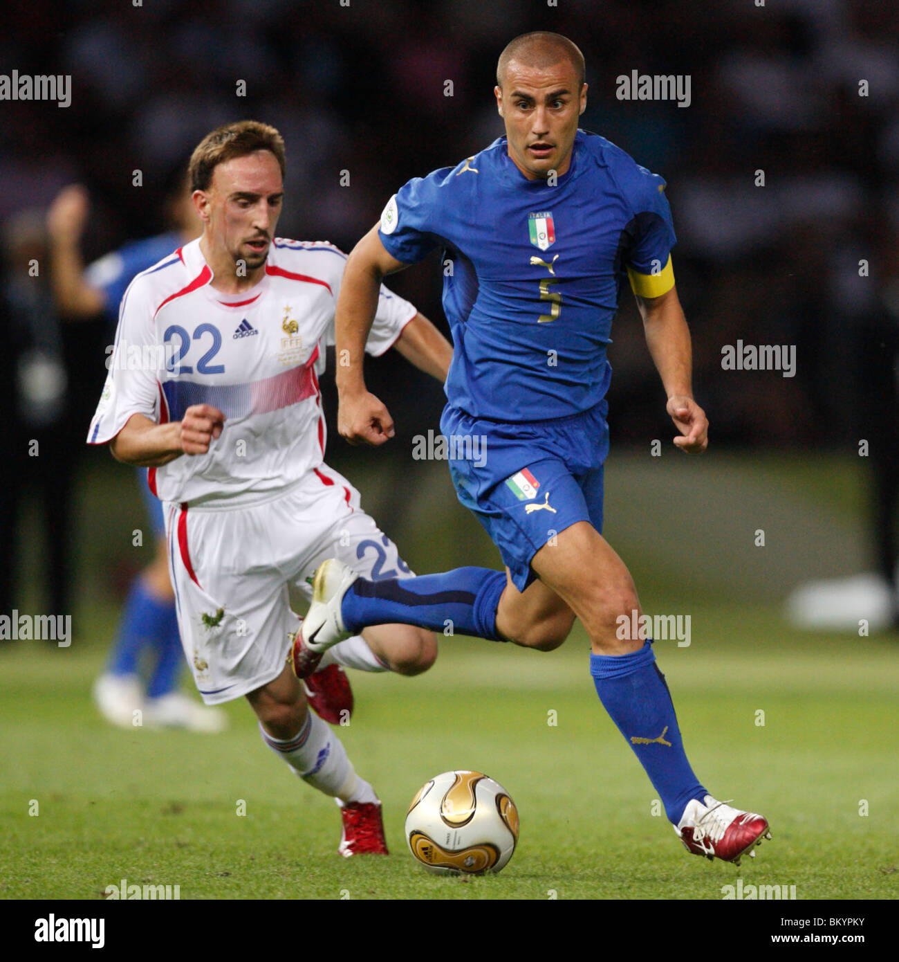 Italy team captain Fabio Cannavaro (r) controls the ball as Franck Ribery of France (l) pursues during the 2006 World Cup final. Stock Photo