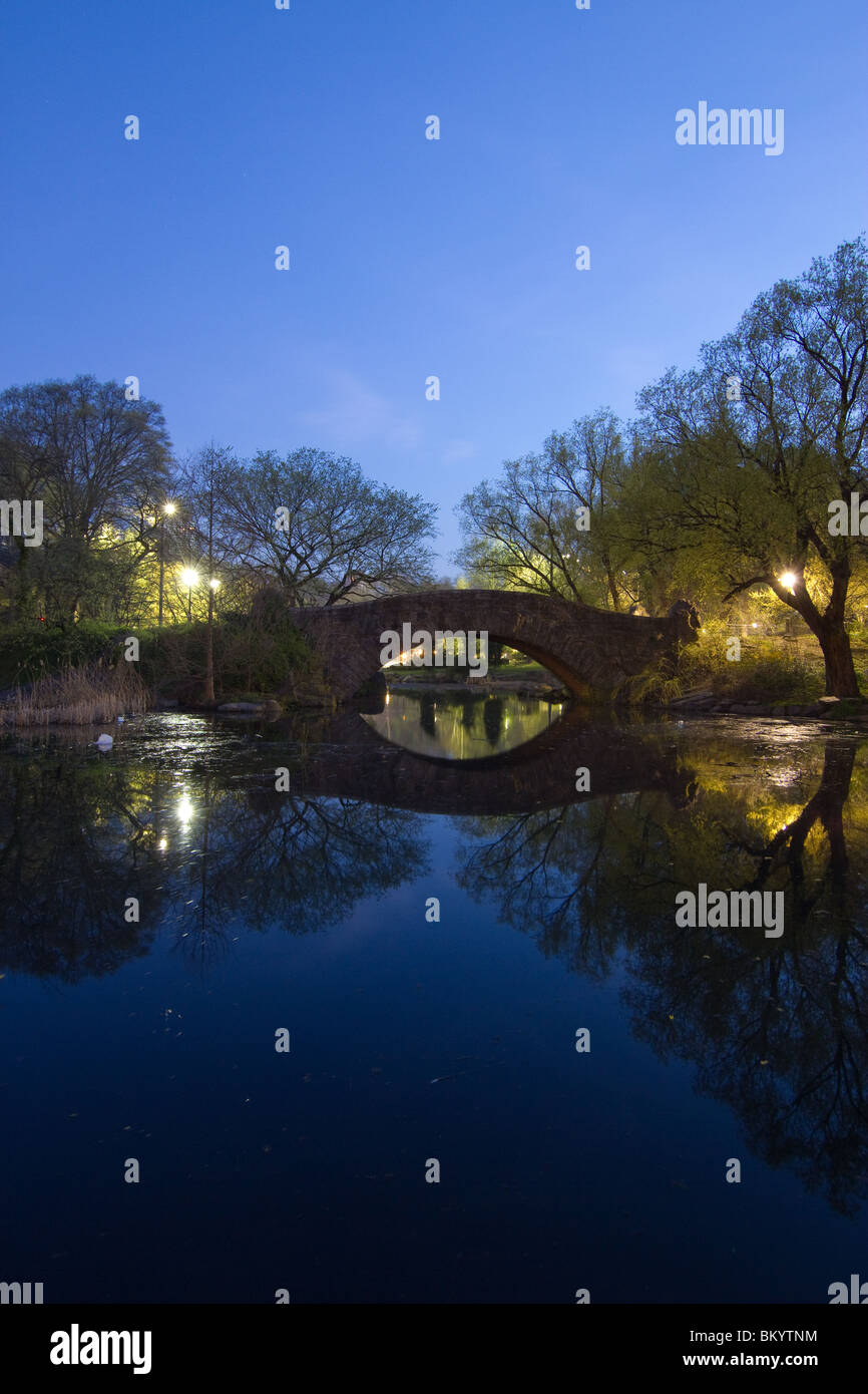 Looking north across the Pond in Central Park at Gapstow Bridge at