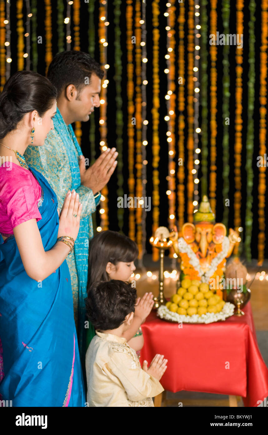 Family praying at Diwali Stock Photo