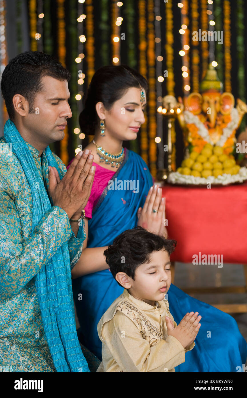 Family praying at Diwali Stock Photo