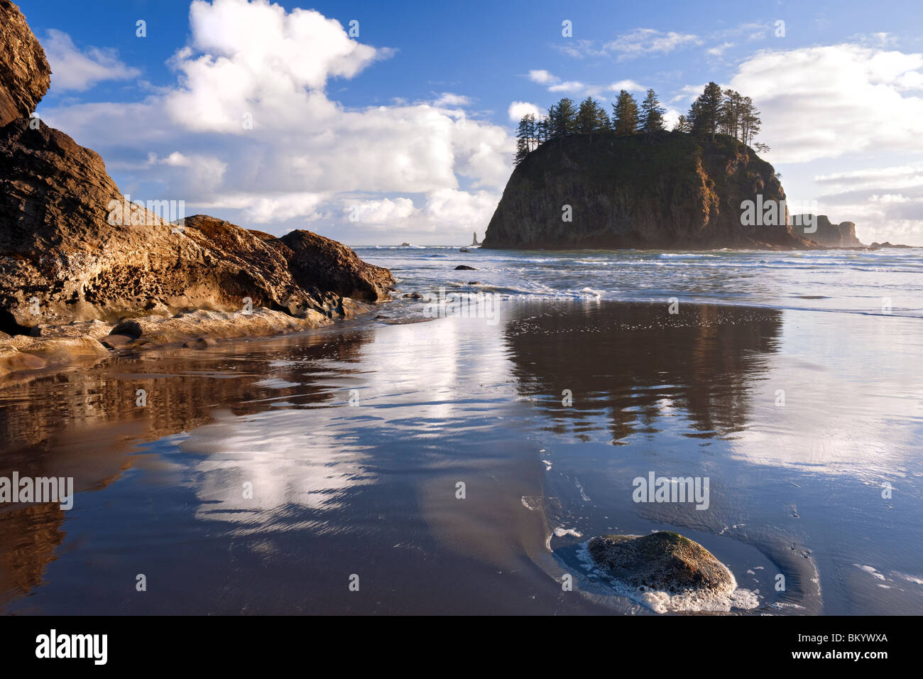 Low tide reflections of Crying Lady Rock at Washington's Second Beach in Olympic National Park. Stock Photo