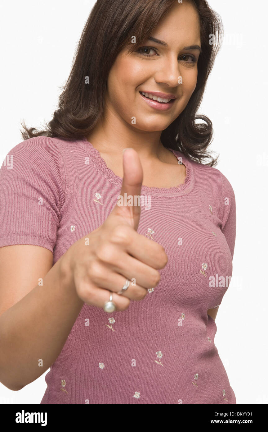 Portrait of a woman showing thumbs up sign Stock Photo - Alamy