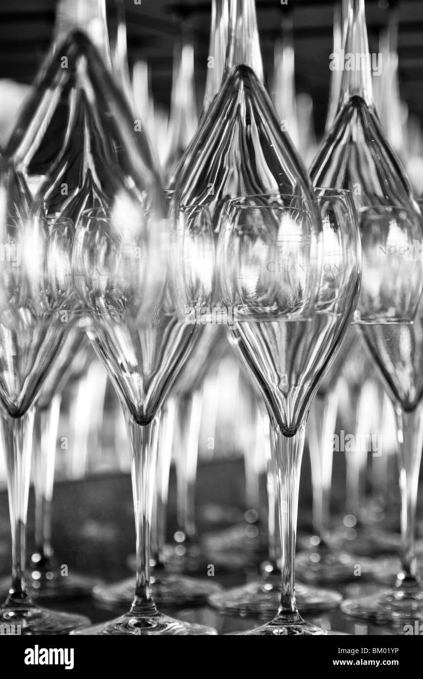 Lines of Domaine Chandon wine glasses upright and upside down. Stock Photo
