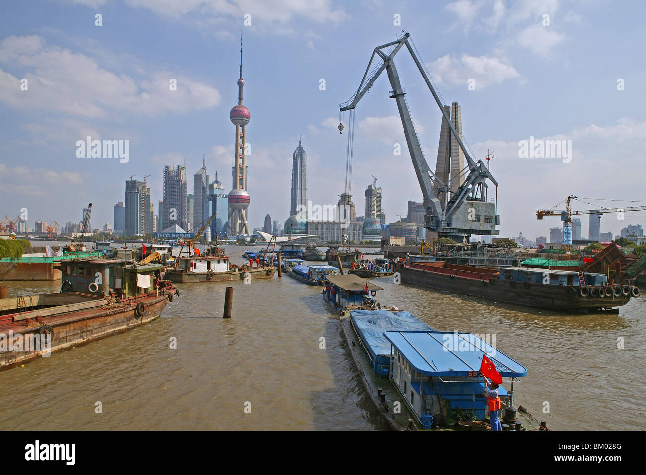 Harbour, View from Waibaidu Bridge, Huangpu-River, Pudong, line of freight barges, chinese flag Stock Photo