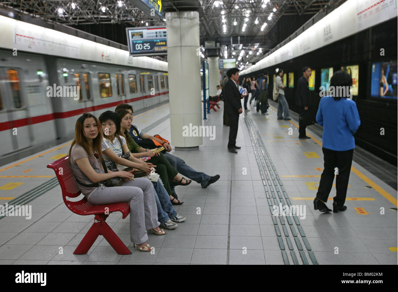 Metro Shanghai, mass transportation system, subway, public transport, underground station, waiting passengers, People's Square Stock Photo