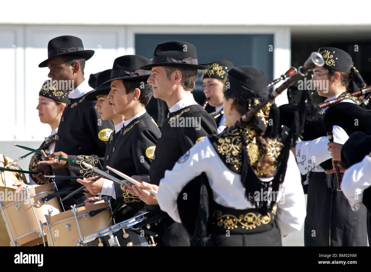 The 'Jose Pedro Big Band' of men, women, boys and girls in Viana do Castelo playing drums and bagpipes Stock Photo