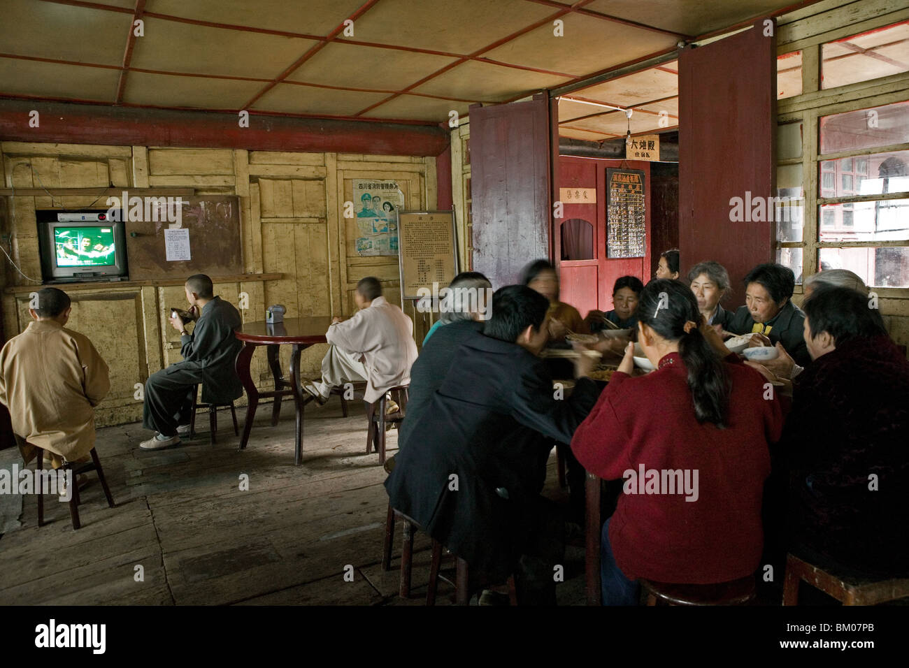 monks having lunch, TV, canteen of the monastery, Xixiang Chi monastery and temple, Elephant Bathing Pool, China, Asia, World He Stock Photo