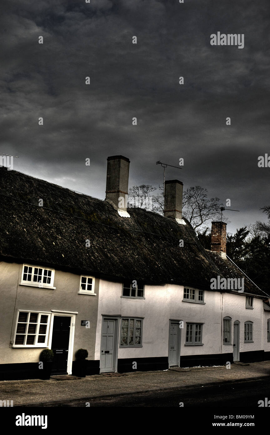 A Row Of Old Thatched Country Cottages In Suffolk England Under A